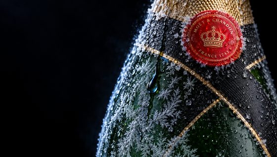 Macro frost blooming across the green glass and red seal